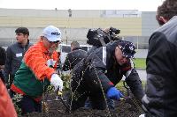 JSC Special Economic Zone Lipetsk General Director Ivan Koshelev (black jacket/cap) and Yokohama R.P.Z. General Director Shigeru Nakano (orange jacket) pitch in at tree-planting ceremony