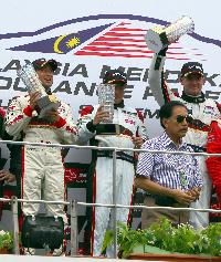 Team drivers (left to right) Hiroshi Hamaguchi, Mok Weng Sun, Craig Baird with championship trophies.