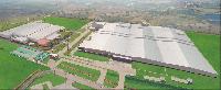 Perspective drawing of the PC/LT tire plant (right) after its third-term expansion