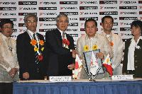 Yokohama Rubber President Nagumo and CDC President and CEO Ricafort shake hands after signing the contract