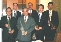 The four recipients and their plaques. In the back row, President Tony Stonis (right) and Vice President Tim Stonis of Cardolite Corporation.