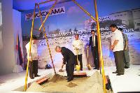 Yokohama Rubber President Tadanobu Nagumo in action to bury a time capsule to commemorate the ground breaking ceremony
