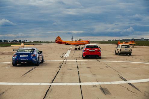 Scene from a show featuring drift cars, racing cars and airplanes