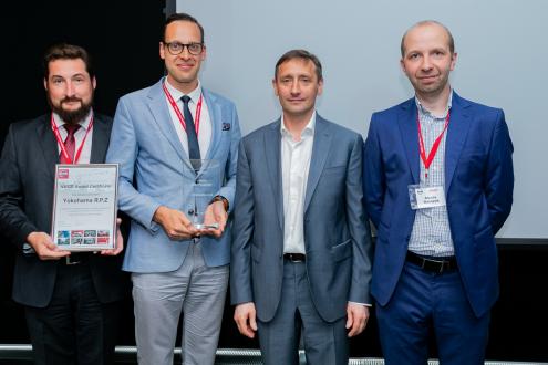 Scene from awards ceremony, managers from Yokohama R.P.Z and our Russia tire sales subsidiary Yokohama Russia L.L.C. (two on far left) accept award from  Nissan Manufacturing Rus officials (two on far right)