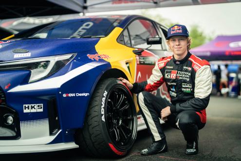 Kalle Rovanperä posing with a hand on an ADVAN NEOVA AD09 tire