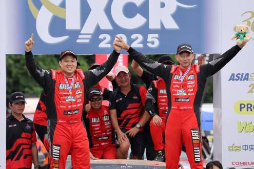 Team Mitsubishi Ralliart team members celebrate winning  the overall championship
